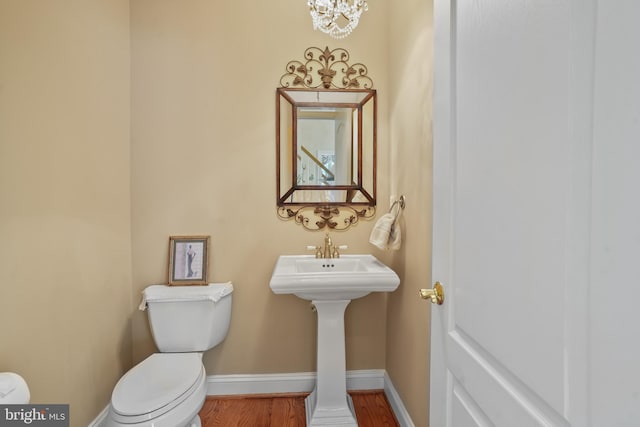 2860 Pfefferkorn Rd, West Friendship, MD 21794 - bathroom featuring toilet, baseboards, wood finished floors, and a chandelier