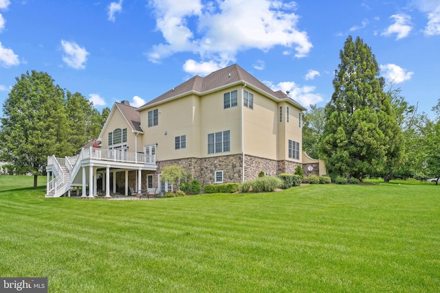 2860 Pfefferkorn Rd, West Friendship, MD 21794 - rear view of house with stone siding, stucco siding, a deck, stairway, and a lawn