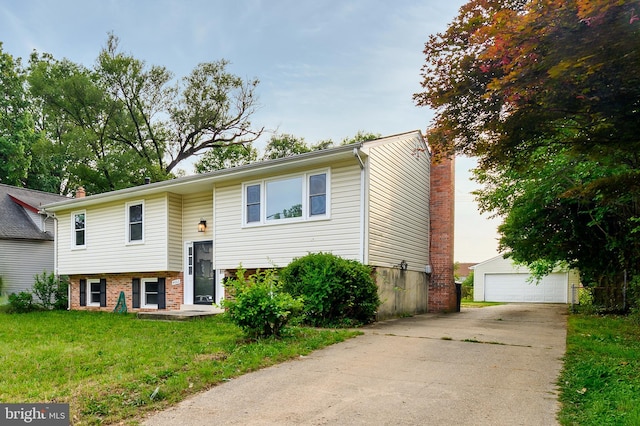 4002 52nd St, Bladensburg, MD 20710 - bi-level home with a chimney, an outdoor structure, a front yard, a detached garage, and brick siding