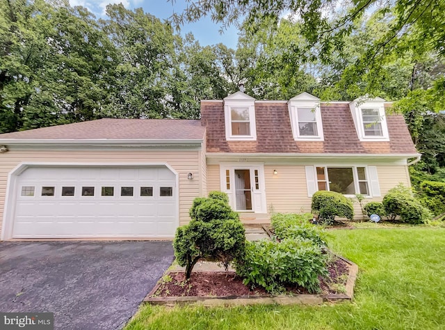 13109 Mica Ct, Silver Spring, MD 20904 - view of property featuring asphalt driveway, roof with shingles, an attached garage, and a front lawn