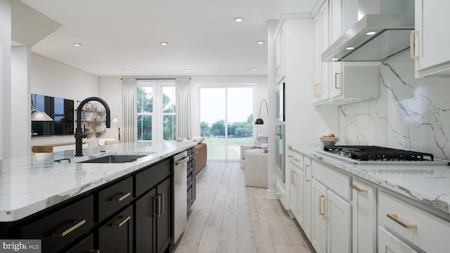 42096 Picasso Sq, Ashburn, VA 20148 - kitchen featuring wall chimney range hood, a sink, white cabinetry, dark cabinets, and decorative backsplash