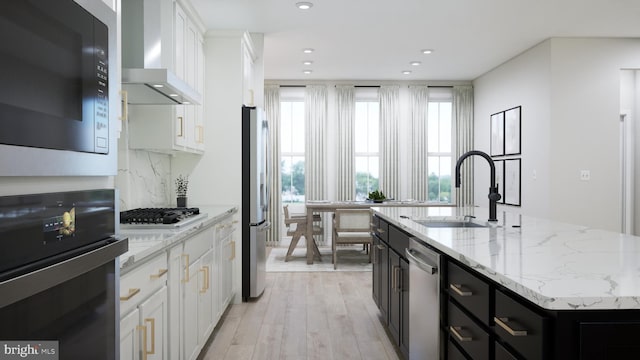 42096 Picasso Sq, Ashburn, VA 20148 - kitchen with appliances with stainless steel finishes, wall chimney range hood, a sink, an island with sink, and white cabinetry
