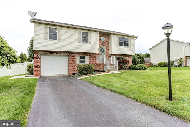 1667 Beech Ln, Hanover, PA 17331 - bi-level home with brick siding, an attached garage, and driveway