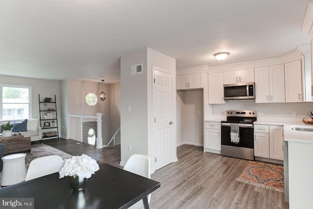 1667 Beech Ln, Hanover, PA 17331 - kitchen with stainless steel appliances, light wood-style floors, white cabinetry, light countertops, and open floor plan