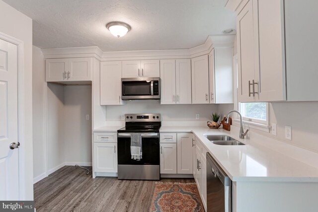 1667 Beech Ln, Hanover, PA 17331 - kitchen featuring appliances with stainless steel finishes, a sink, light wood-type flooring, and white cabinets