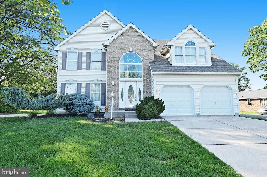 9710 Magledt Rd, Baltimore, MD 21234 - view of front facade featuring a front yard, driveway, roof with shingles, and a garage