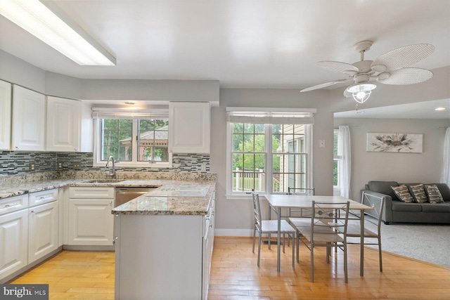 9710 Magledt Rd, Baltimore, MD 21234 - kitchen with decorative backsplash, white cabinetry, and light wood-style floors