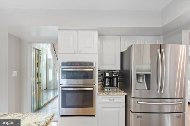9710 Magledt Rd, Baltimore, MD 21234 - kitchen with appliances with stainless steel finishes, light stone countertops, and white cabinetry