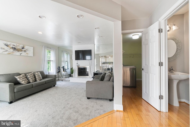 9710 Magledt Rd, Baltimore, MD 21234 - living area featuring light wood finished floors, a brick fireplace, and recessed lighting
