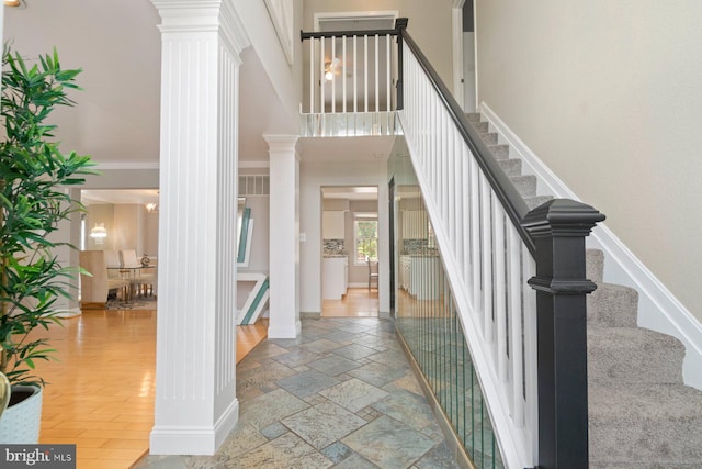 9710 Magledt Rd, Baltimore, MD 21234 - stairs with decorative columns, a high ceiling, ornamental molding, and stone tile floors