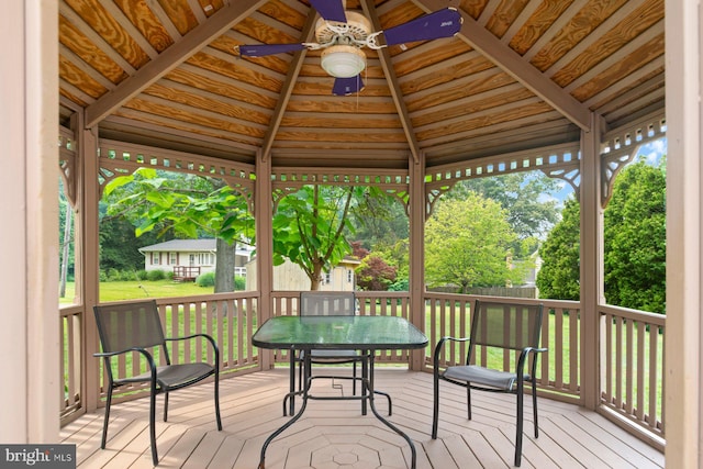 9710 Magledt Rd, Baltimore, MD 21234 - deck featuring ceiling fan, a gazebo, outdoor dining area, and view of scattered trees