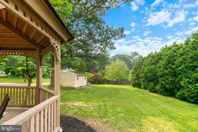 9710 Magledt Rd, Baltimore, MD 21234 - view of yard featuring a wooden deck and a storage unit