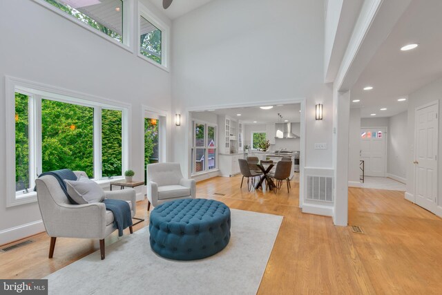 5001 14th St N, Arlington, VA 22205 - living room featuring light wood-type flooring, baseboards, recessed lighting, and a high ceiling