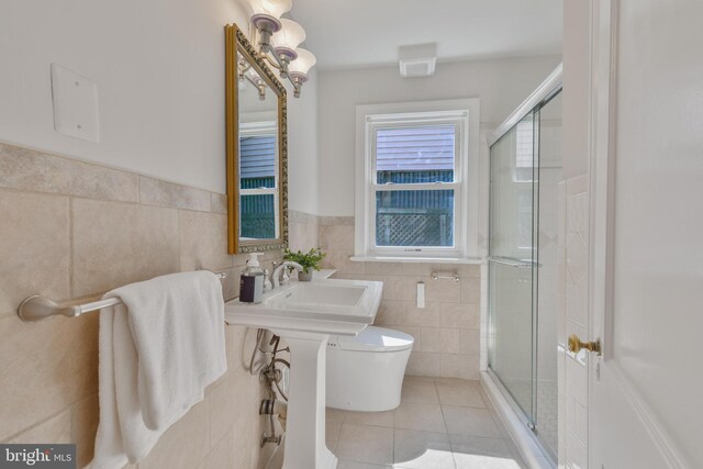 5001 14th St N, Arlington, VA 22205 - full bath featuring tile walls, tile patterned floors, a stall shower, toilet, and wainscoting