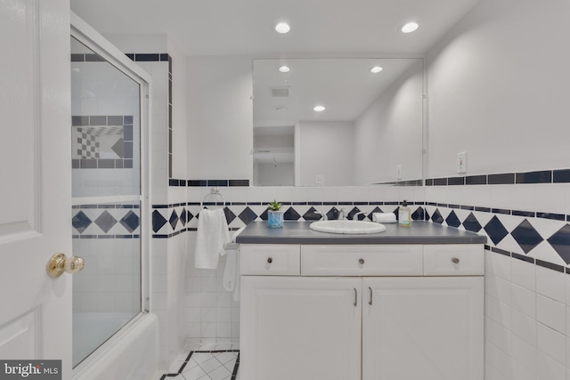 5001 14th St N, Arlington, VA 22205 - full bathroom featuring tile walls, vanity, shower / bath combination with glass door, recessed lighting, and tile patterned floors