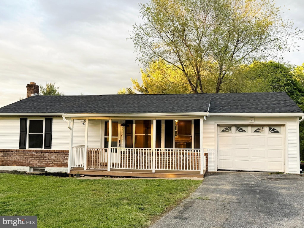2969 Exeter Dr, York, PA 17403 - ranch-style home featuring covered porch, an attached garage, a chimney, asphalt driveway, and a front lawn