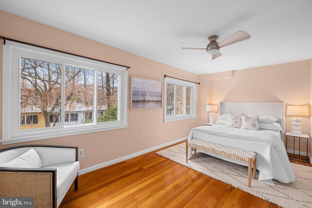 320 G St SW, Washington, DC 20024 - bedroom featuring baseboards, multiple windows, wood finished floors, and ceiling fan