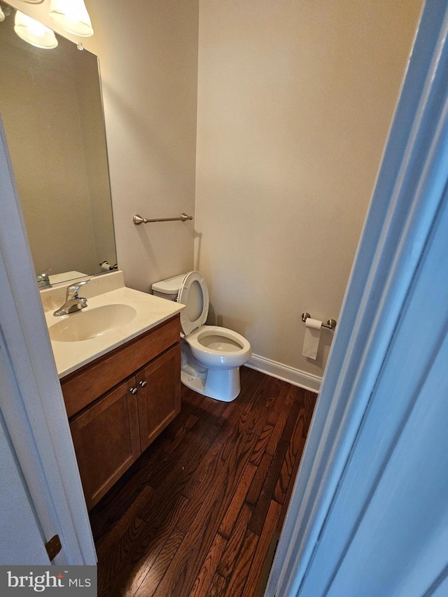 204 Turtle Cv Unit 116, Laurel, DE 19956 - half bath with wood finished floors, toilet, vanity, and baseboards
