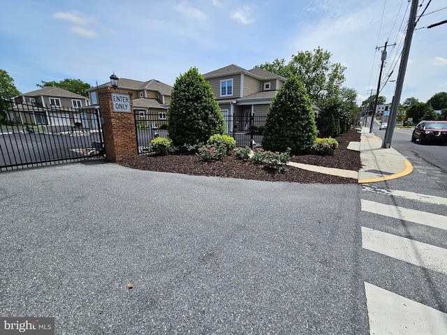 204 Turtle Cv Unit 116, Laurel, DE 19956 - view of asphalt road featuring street lights, sidewalks, and a residential view