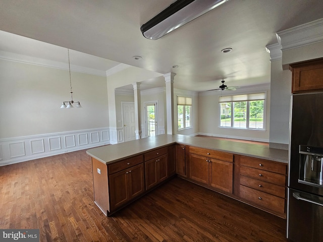 204 Turtle Cv Unit 116, Laurel, DE 19956 - kitchen with black fridge with ice dispenser, ornamental molding, ornate columns, ceiling fan, and dark wood-style flooring