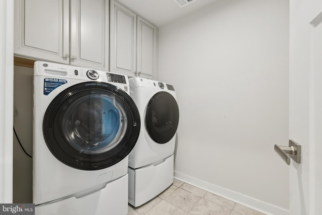 121 Mountain Path Ln, Stafford, VA 22554 - washroom featuring washing machine and dryer, cabinet space, baseboards, and light tile patterned floors