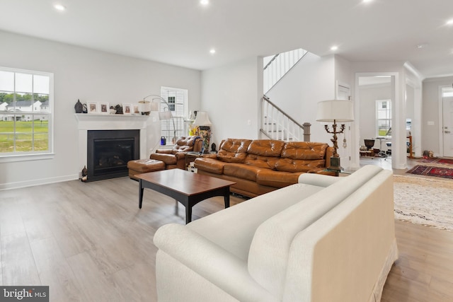 121 Mountain Path Ln, Stafford, VA 22554 - living room featuring light wood-type flooring, healthy amount of natural light, recessed lighting, stairway, and a glass covered fireplace
