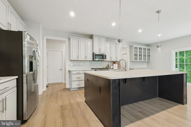 121 Mountain Path Ln, Stafford, VA 22554 - kitchen with stainless steel appliances, light wood finished floors, decorative backsplash, light countertops, and recessed lighting