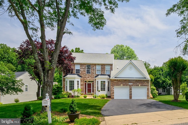 10604 Sourwood Ct, Laurel, MD 20723 - view of front of house featuring driveway, brick siding, an attached garage, a front yard, and a shingled roof