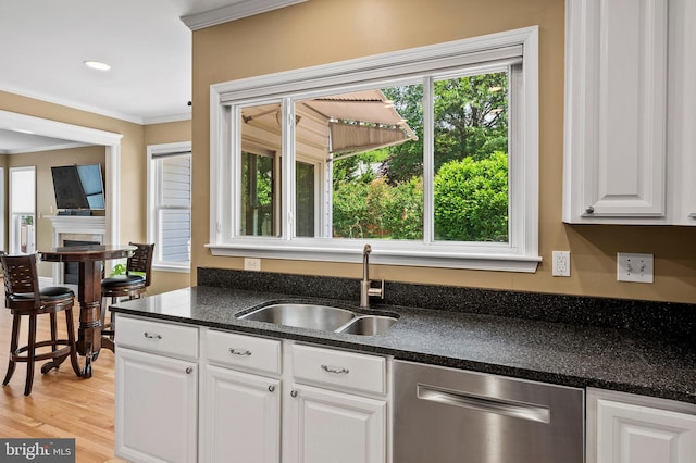 10604 Sourwood Ct, Laurel, MD 20723 - kitchen with stainless steel dishwasher, crown molding, plenty of natural light, white cabinetry, and light wood-style flooring