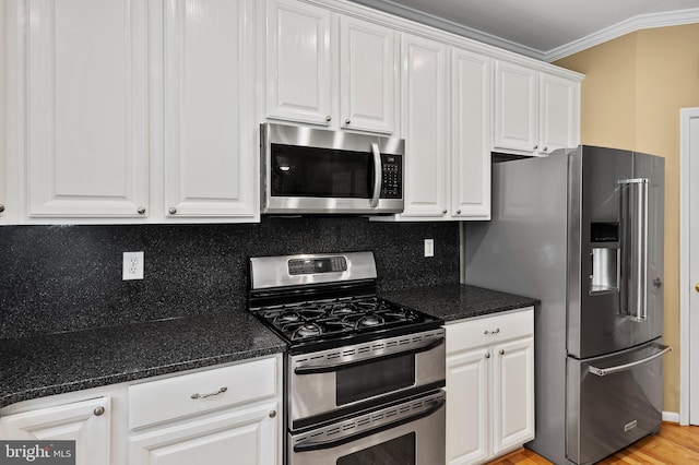 10604 Sourwood Ct, Laurel, MD 20723 - kitchen with appliances with stainless steel finishes, white cabinetry, crown molding, dark stone countertops, and backsplash