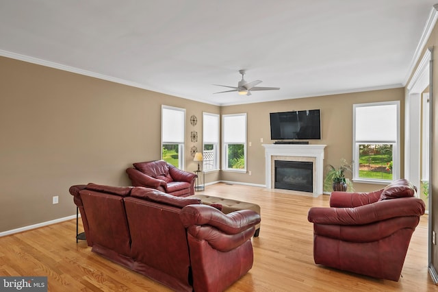 10604 Sourwood Ct, Laurel, MD 20723 - living area with healthy amount of natural light, a ceiling fan, ornamental molding, light wood-type flooring, and a high end fireplace
