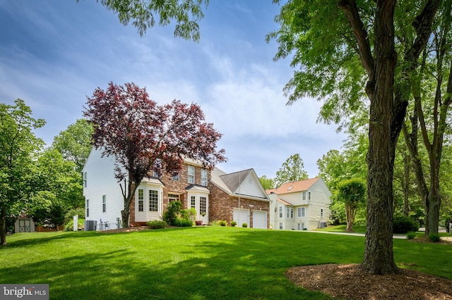 10604 Sourwood Ct, Laurel, MD 20723 - view of front facade with a front lawn, a garage, and brick siding