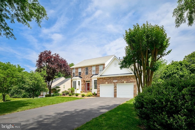 10604 Sourwood Ct, Laurel, MD 20723 - view of front facade featuring asphalt driveway, a front yard, brick siding, and an attached garage