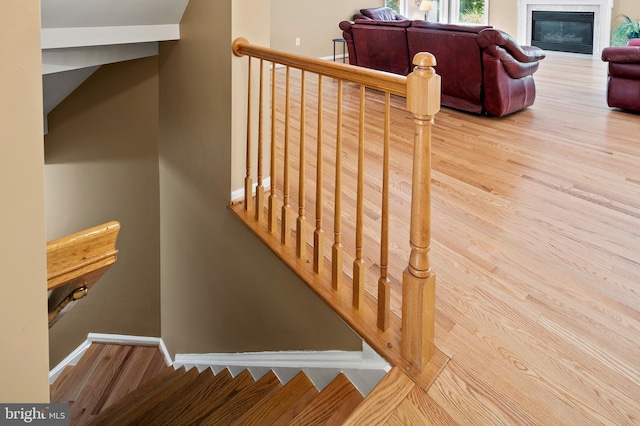 10604 Sourwood Ct, Laurel, MD 20723 - stairs featuring wood finished floors and a glass covered fireplace