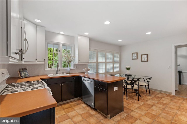 33 Duffield Pl, Princeton, NJ 08540 - kitchen with dishwasher, a sink, white range with gas cooktop, light countertops, and recessed lighting