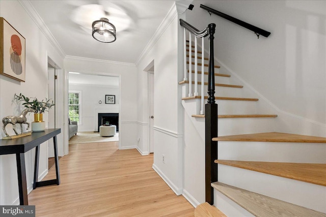 33 Duffield Pl, Princeton, NJ 08540 - foyer entrance with light wood-type flooring, stairs, a fireplace, baseboards, and ornamental molding
