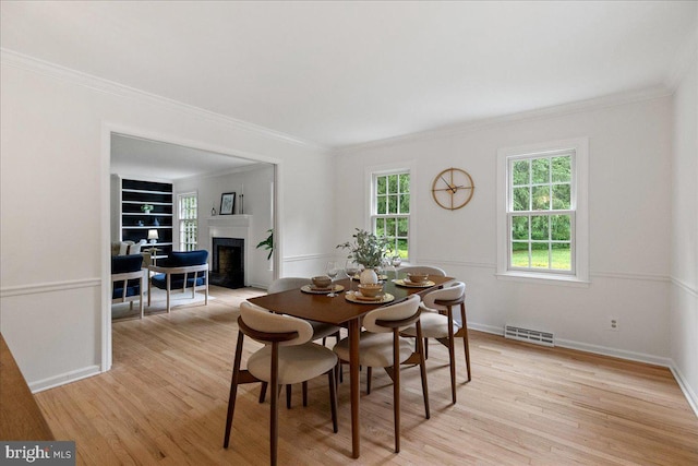 33 Duffield Pl, Princeton, NJ 08540 - dining area featuring light wood-style floors, a fireplace, crown molding, and baseboards