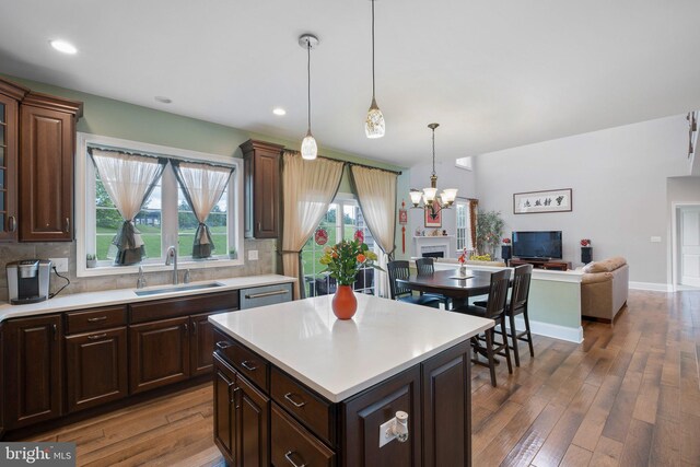 213 Athena Ct, Wilmington, DE 19808 - kitchen with a sink, light countertops, wood-type flooring, a chandelier, and tasteful backsplash