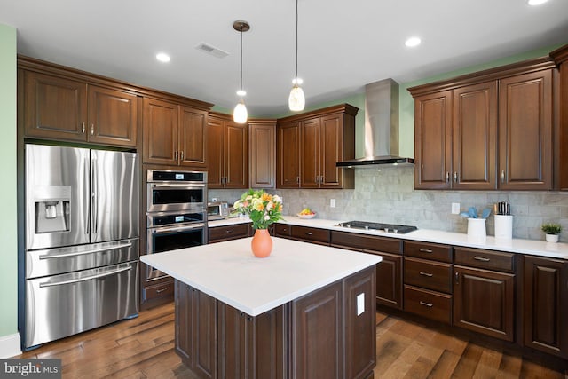 213 Athena Ct, Wilmington, DE 19808 - kitchen featuring appliances with stainless steel finishes, wall chimney range hood, dark wood-type flooring, light countertops, and tasteful backsplash
