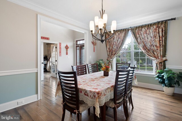 213 Athena Ct, Wilmington, DE 19808 - dining space featuring a chandelier, ornamental molding, baseboards, and hardwood / wood-style floors