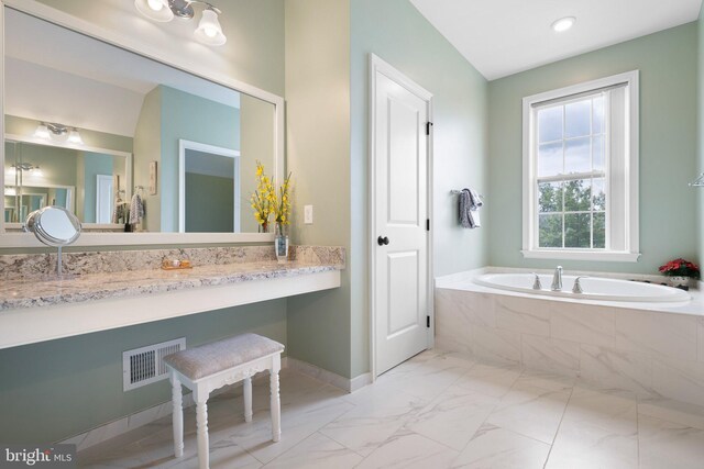 213 Athena Ct, Wilmington, DE 19808 - bathroom featuring marble look tile flooring, a garden tub, baseboards, and vanity