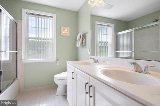 213 Athena Ct, Wilmington, DE 19808 - full bathroom featuring toilet, double vanity, enclosed tub / shower combo, and baseboards