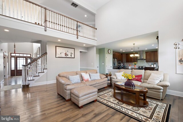 213 Athena Ct, Wilmington, DE 19808 - living area with baseboards, wood finished floors, a chandelier, a high ceiling, and recessed lighting