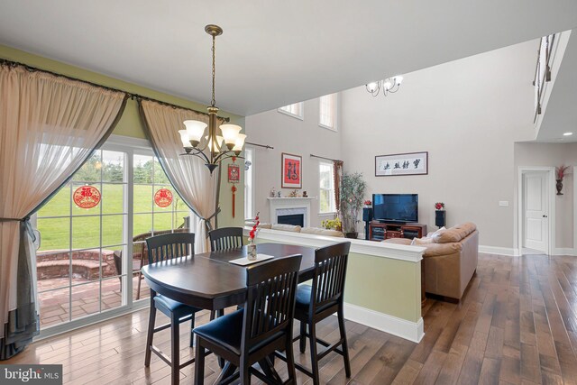 213 Athena Ct, Wilmington, DE 19808 - dining room featuring a chandelier, healthy amount of natural light, hardwood / wood-style floors, and a towering ceiling
