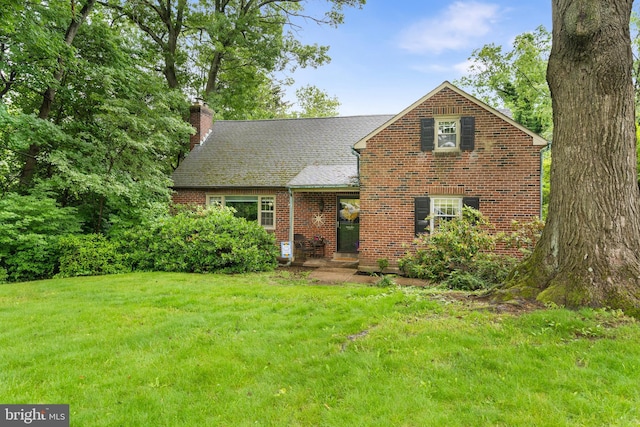 625 Lindley Rd, Glenside, PA 19038 - view of front of house with a chimney, a front yard, and brick siding