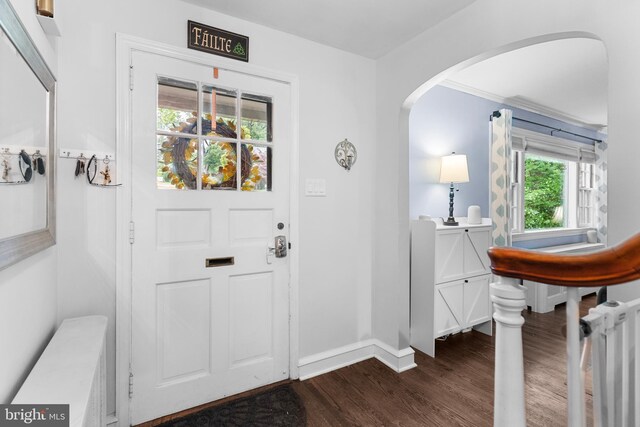 625 Lindley Rd, Glenside, PA 19038 - foyer with dark wood finished floors, arched walkways, and baseboards