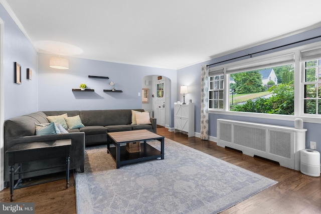 625 Lindley Rd, Glenside, PA 19038 - living area featuring radiator, arched walkways, ornamental molding, wood finished floors, and baseboards