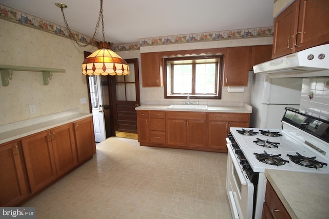 65 Albert Ave, Milltown, NJ 08850 - kitchen featuring white gas stove, wallpapered walls, a sink, under cabinet range hood, and light countertops