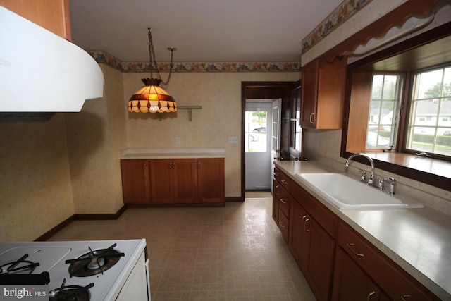 65 Albert Ave, Milltown, NJ 08850 - kitchen featuring a sink, white gas range oven, wallpapered walls, healthy amount of natural light, and light countertops