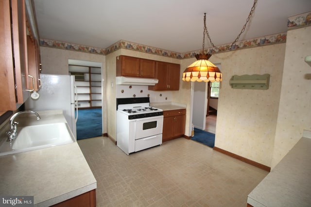 65 Albert Ave, Milltown, NJ 08850 - kitchen featuring white appliances, wallpapered walls, a sink, under cabinet range hood, and brown cabinetry